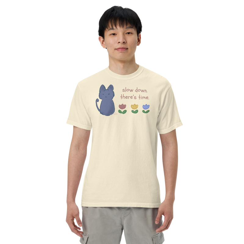 Model wearing a ivory Comfort Colors T-shirt with a blue cat, three flowers, and 'Slow down, there's time' lettering.