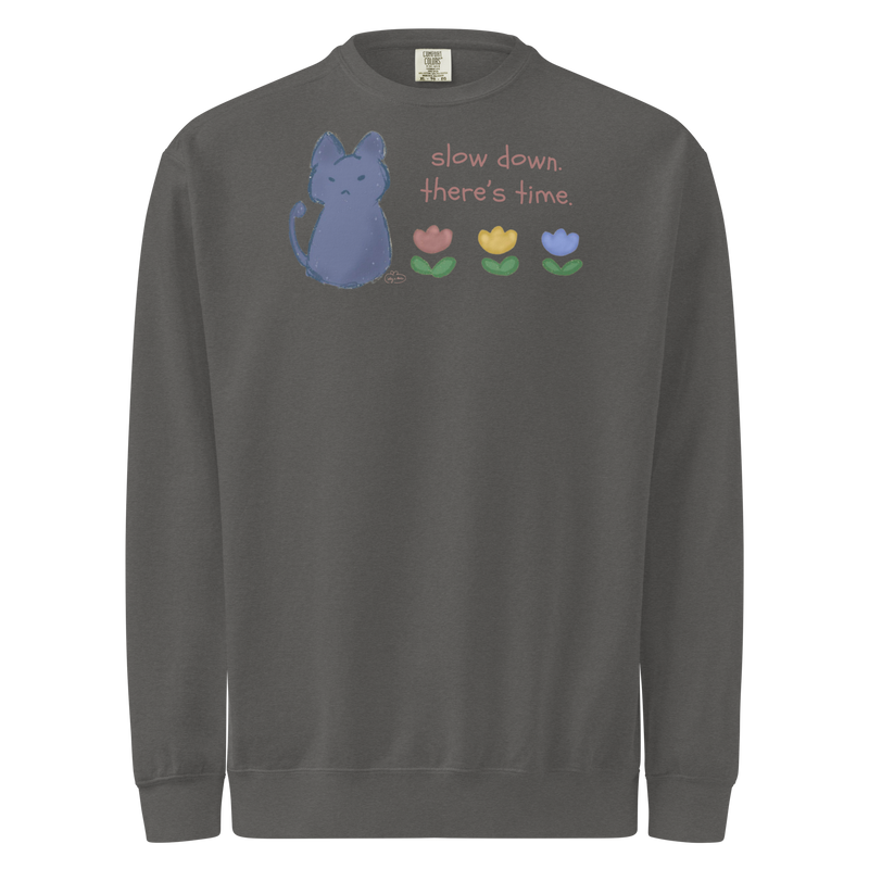 Charcoal grey garment-dyed sweatshirt with a blue cat, three flowers, and 'Slow down, there's time' lettering.