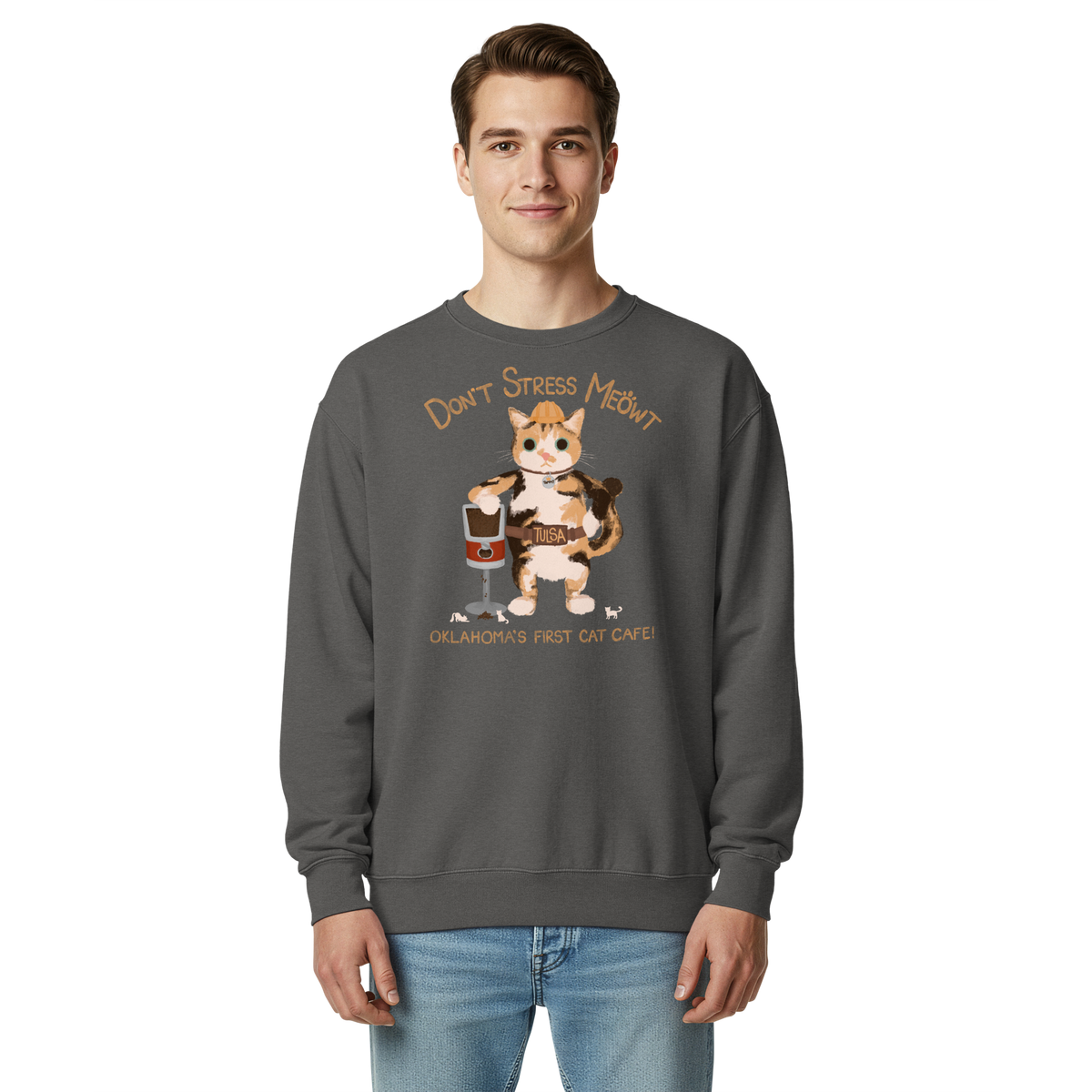 Model wearing a pepper charcoal grey garment-dyed sweatshirt with a calico cowboy cat and Don't Stress Meowt cat cafe lettering.