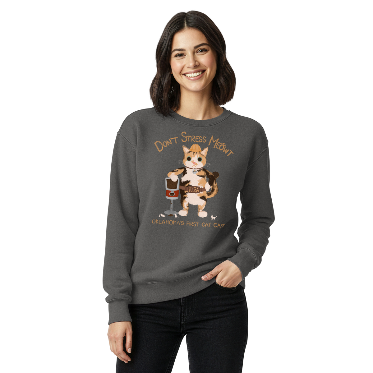 Model wearing a pepper charcoal grey garment-dyed sweatshirt with a calico cowboy cat and Don't Stress Meowt cat cafe lettering.