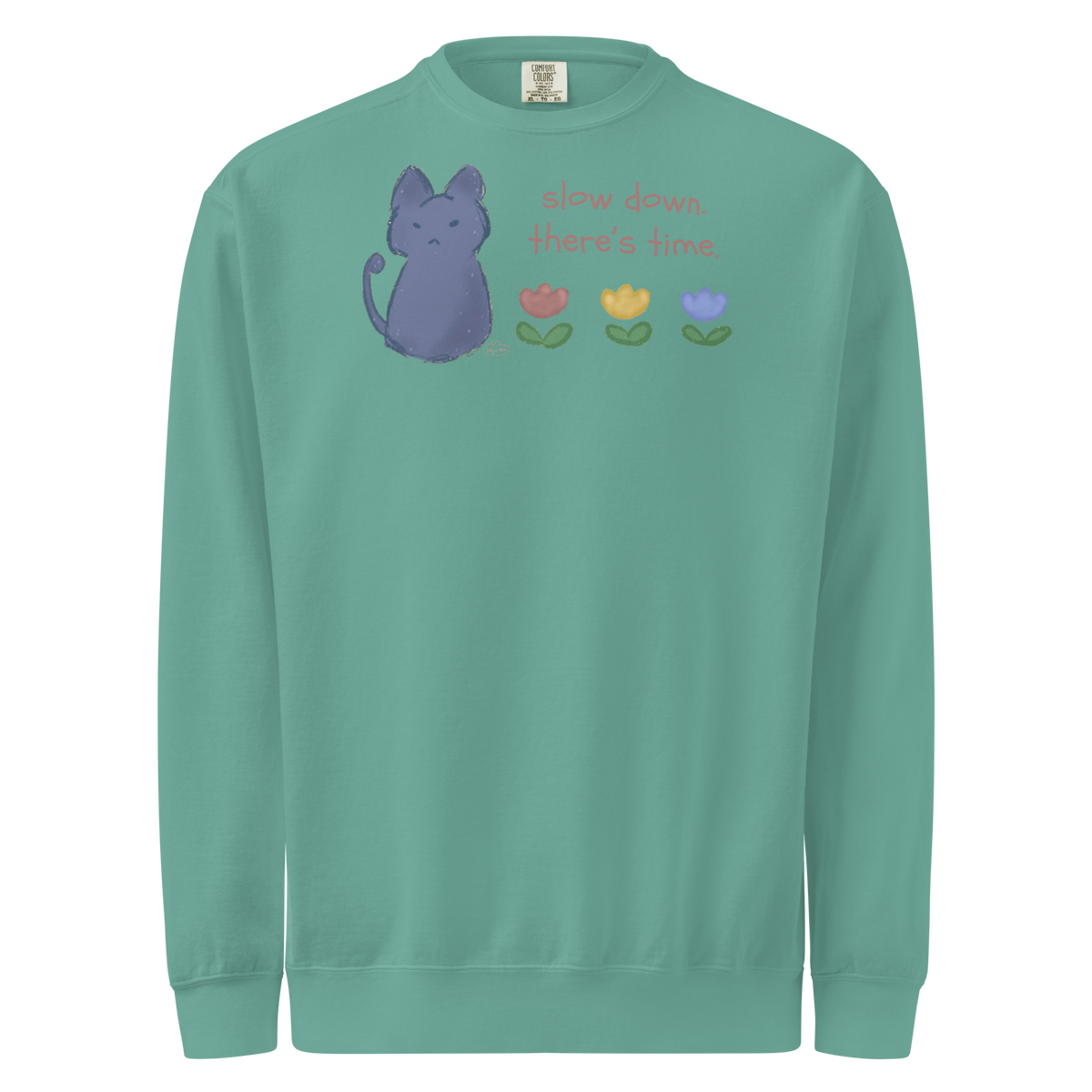 Seafoam green garment-dyed sweatshirt with a blue cat, three flowers, and 'Slow down, there's time' lettering.