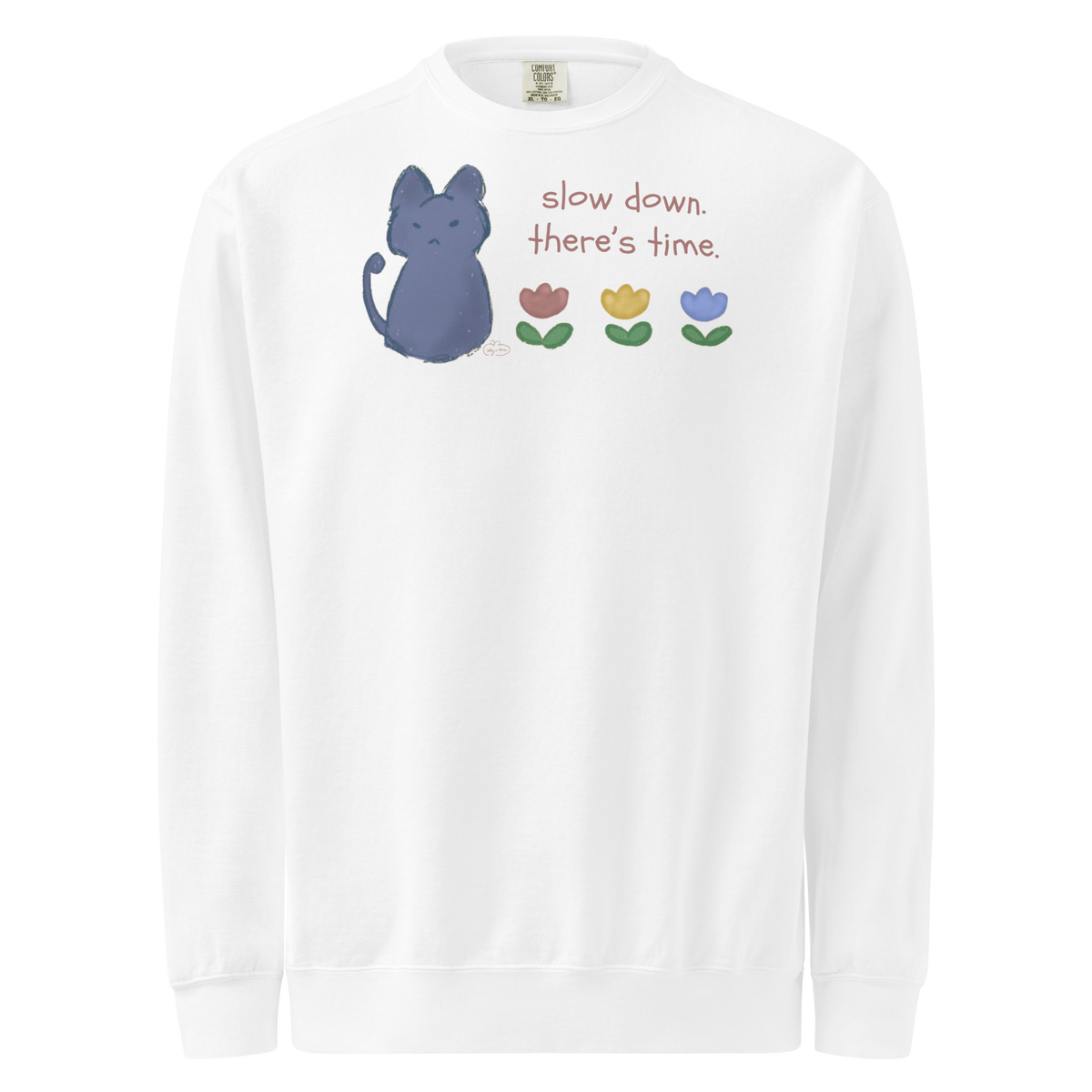 White garment-dyed sweatshirt with a blue cat, three flowers, and 'Slow down, there's time' lettering.