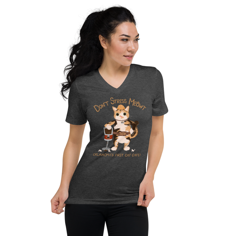 Model wearing a dark heather grey V-neck T-shirt with a calico cowboy cat and Don't Stress Meowt cat cafe lettering.