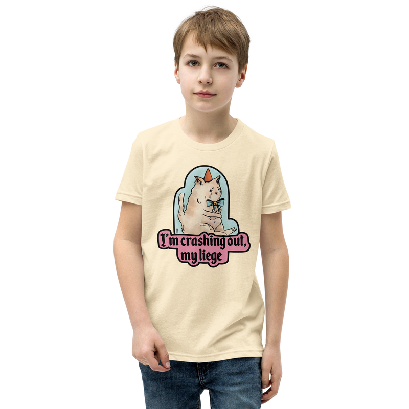 Natural cream youth T-shirt with a tearful cat in a party hat and 'I'm crashing out, my liege' lettering.